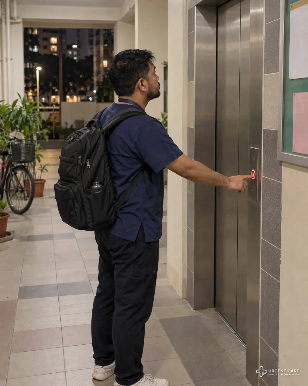 A doctor in navy scrubs with a medical backpack presses the lift button in an HDB block lobby at night
